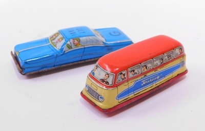 Tinplate models, comprising British made wind up cars, an automatic garage and a London red bus, no keys. - 4