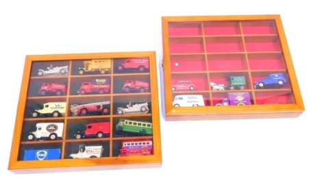 Two yew model car display cabinets, enclosing contents of Models of Yesteryear advertising buses and wagons. (2 cases)