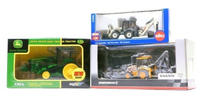 Three tractor models, comprising Ertl/Britain's John Deere 1-32 scale model 4273 green tractor, a Siku back hoe loader model 3531 1-50 scale, and a Motor Art Volvo 1-50 scale tractor, boxed. (3)