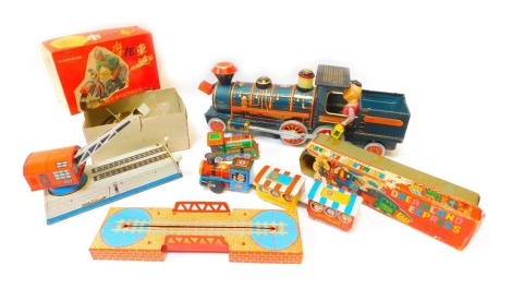 Tin plate toys, comprising a tinplate locomotive for the Frontier 3673, a Dreamland Express wind up engine and bridge, tinplate crane, and a clockwork Chinese motorcycle, boxed. (4)