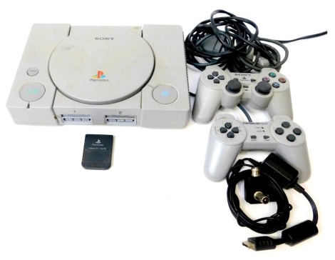 A Sony Playstation model SCPH7002 console, Sony Playstation DualShock analogue controller, other controller, etc.