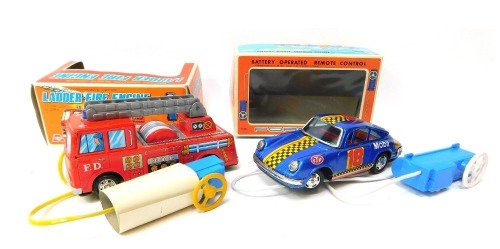 An Asahi battery operated remote control tinplate ladder fire engine, with top light and siren, and a Yone battery operated remote controlled Porsche, boxed. (2)