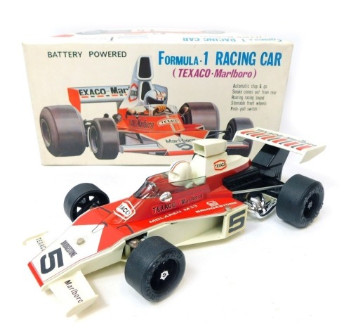 An Alps battery powered Formula 1 racing car Texaco Malboro, boxed.