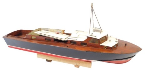 A wooden model long boat, painted in black and red, 87cm wide.