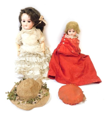 A collection of bisque headed dolls, comprising one in red dress with brown fixed eyes and teeth, on articulated limb body, marked X to head, an Armand Marseille bisque headed doll numbered 393M, in lace frilled dress, 38cm high. (2)