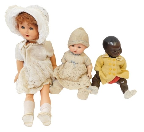 Three dolls, comprising a bisque headed doll stamped AS numbered 261-4, in knitted gown with fixed blue eyes, a growl doll with fixed blue eyes, and a baby doll stamped 271 in yellow cardigan. (3)