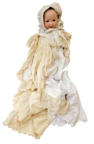 A German bisque headed doll, numbered 914 and 12, with brown fixed eyes and open mouth, on painted limbed body, in a cream and gold flowing night gown, 59cm high.