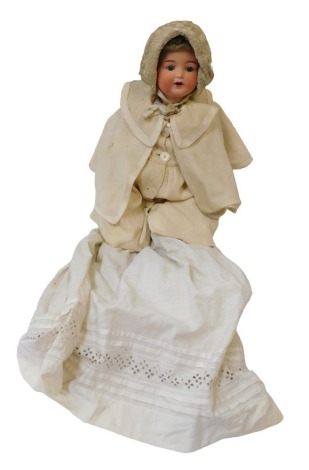 An Armand Marseille bisque headed German porcelain doll, with roll blue eyes and open mouth, on papier mache articulated limbed body, in flowing dress, 47cm high.