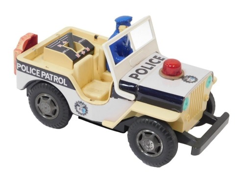 A Japanese tinplate police clockwork Jeep.