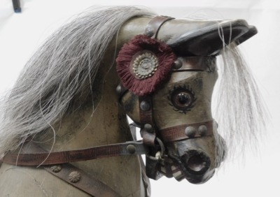 A 20thC rocking horse, the dapple grey horse with bound saddle, on a trestle base, 89cm high, 75cm wide, 38cm deep. - 2