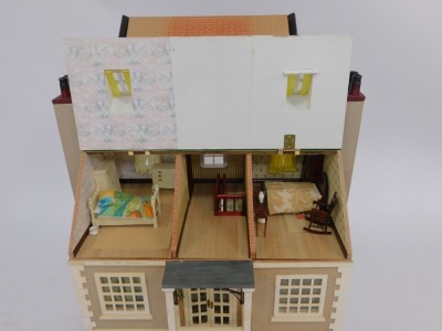 A Tudor style three storey wooden doll's house, with brick laid detail, and a slatted roof, 78cm high, 70cm wide, 39cm deep. (AF) - 5