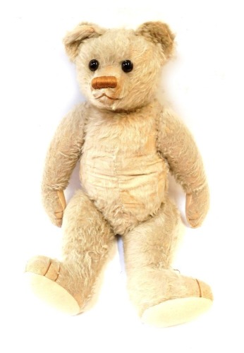 A 1940s plush blonde jointed Teddy bear, in light coloured fur, with wire wool filling, 63cm high.