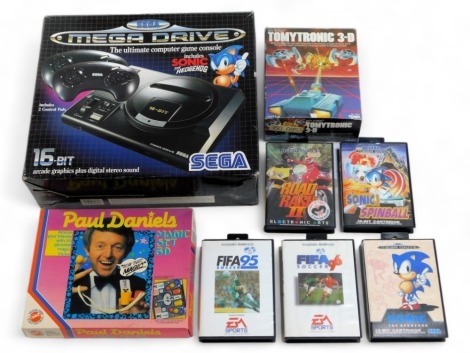 A Sega Megadrive and games, including Sonic Spinball, Sonic The Hedgehog, Fifa Soccer 95, Fifa Soccer 96, with a Tomytronic 3D sky attack and Paul Daniels magic set, boxed. (a quantity)