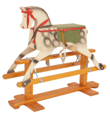 A wooden rocking horse, dapple grey with a green cushioned and lined seat, 80cm high, 89cm wide.