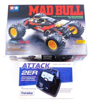 A remote control vehicle, comprising Tamiya Mad Bull 1-10 scale high performance off road racer, kit build, and an Attack 2ER two channel radio control system by Futaba, boxed. (2)