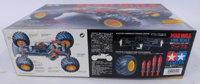 A remote control vehicle, comprising Tamiya Mad Bull 1-10 scale high performance off road racer, kit build, and an Attack 2ER two channel radio control system by Futaba, boxed. (2) - 2