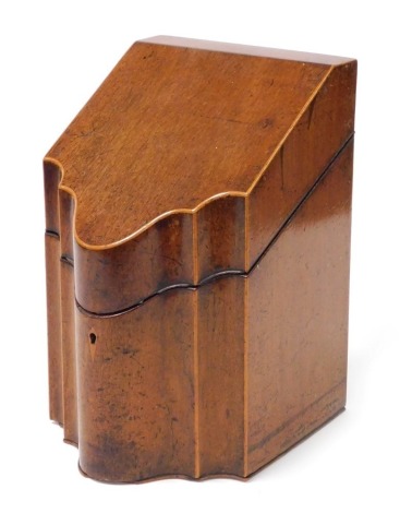 A George III mahogany and boxwood inlaid knife box, of serpentine form, the hinged lid opening to reveal a fitted interior, 32cm high, 20cm wide.