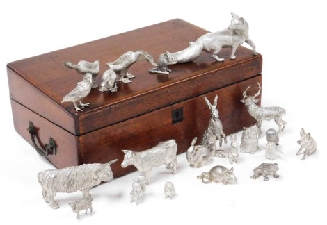 A group of silver plated figures, of animals, birds and a frog, including fox, hare, cow, stage, owls and hedgehog, in a Victorian mahogany box.