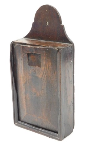 An 18thC oak candle box, with a sliding front opening to reveal three recesses, 30cm high.