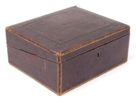 A Victorian Morocco bound writing slope, with tooled and gilt decoration, the hinged lid opening to reveal a velvet writing slope and fitted interior, 31cm wide, 26.5cm deep.