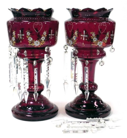 A pair of late 19thC ruby glass lustres, with enamel decoration of floral swags, with prismatic clear glass drops, 37cm high.