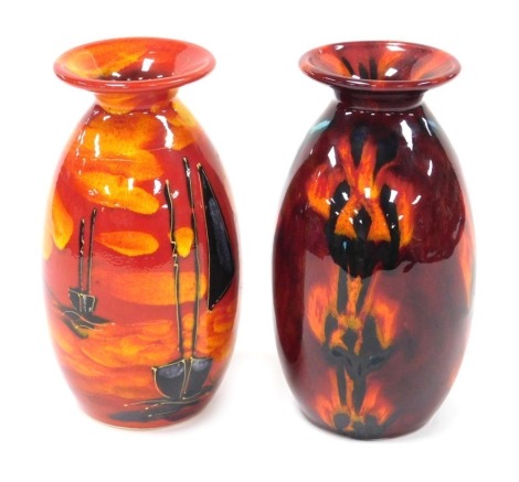 An Anita Harris studio pottery vase, decorated with sailing boats on a red and gold ground, painted signature, and printed marks, 21cm high, and a further vase, decorated with abstract figures against a red ground, printed and painted marks, 21cm high.