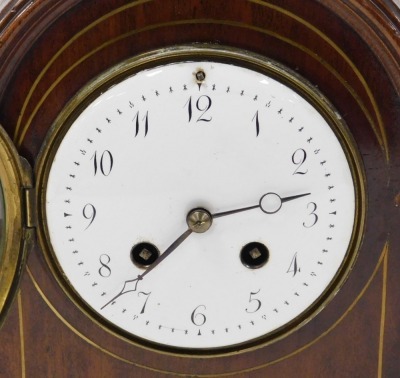 A late 19thC mahogany cased mantel clock, circular enamel dial bearing Arabic numerals, eight day movement by L. Marti et Cie with coil strike, the case of domed and pedimented form, with brass inlay and brass capped reeded quarter columns, raised on a re - 2