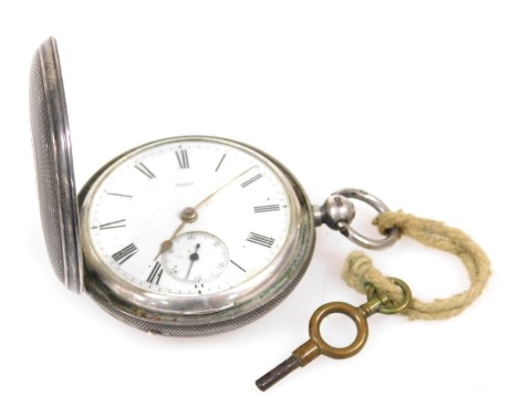 A Victorian silver cased hunter pocket watch, key wind, circular enamel dial bearing Roman numerals, subsidiary seconds dial, the case with engine turned decoration, vacant shield and garter reserve, with key, London 1872.