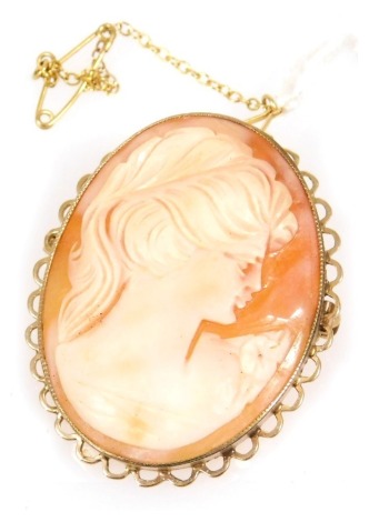 A 9ct gold and shell cameo brooch, bust portrait of a lady in an oval frame, with safety pin as fitted.