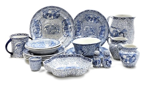 A group of early 20thC Adams blue and white pottery tablewares, decorated in a Chinoiserie pattern, including milk and cream jugs, twin handle loving cup, cruet set, bowls and plates. (qty)