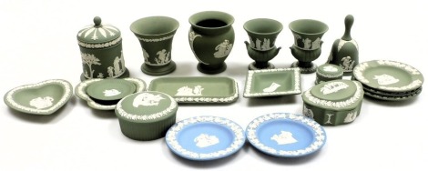 A group of Wedgwood green and light blue Jasper pottery, including vases, ashtrays, dressing table dishes, a bell and a jar and cover.