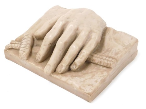 After the Antique. A faux marble fibre glass casting of a hand, upon a rope, on a naturalistic rectangular ground, 25cm wide.