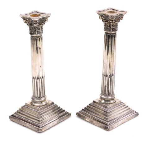 A pair of George V loaded silver Corinthian column candlesticks, Birmingham 1911, 34.53oz all in, 24cm high.