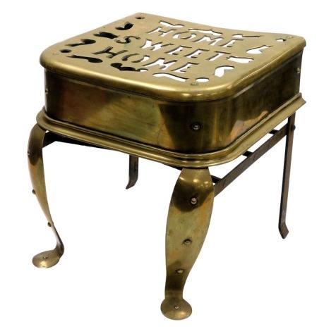 A 19thC brass footman, pierced to the top "Home Sweet Home", raised on front cabriole legs, 34cm wide.