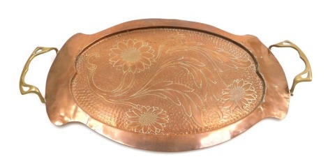 A late 19thC Arts and Crafts copper and brass twin handled tray, with hammered and engraved floral decoration, 46cm wide. (AF)