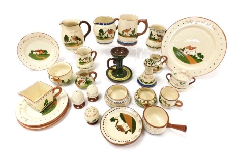 A group of early 20thC Devon Motto ware, including jugs, hat pin holder, salt, pepperettes, chamber stick, and plates. (qty)