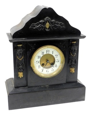 A late 19thC slate mantel clock, circular brass dial with enamel chapter ring bearing Arabic numerals, eight day movement with coil strike, the case of architectural form, with pendulum and key, 43cm high, 35cm wide.