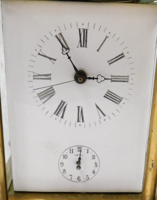 A late Victorian brass cased alarm carriage clock, rectangular white enamel dial bearing Roman numerals, subsidiary alarm dial, the movement with bell strike, case of conventional form with turned pilasters, 17cm high. (AF) - 2