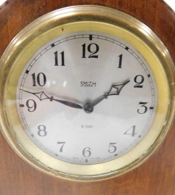 An early 20thC Smiths mahogany cased mantel clock, silvered dial bearing Arabic numerals, eight day clockwork movement, with integral key, the case of domed form, raised on brass feet, 20cm high, and an Edwardian mahogany and inlaid mantel clock, with Swi - 3