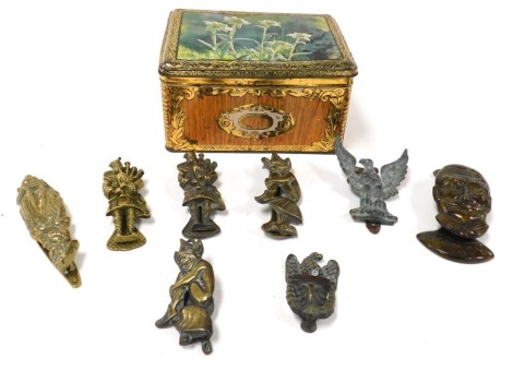 A group of 20thC brass door knockers, including a figural knocker of George V, crinoline lady, two bagpipers, and two pixies. (qty)