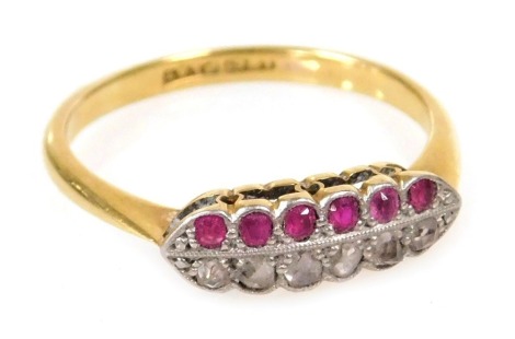 A ruby and diamond twelve stone ring, set with a row of each stone, in white and yellow metal, stamped plat and 18ct, size O, 2.3g.