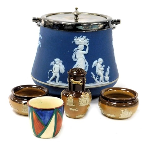 A Clarice Cliff Bizarre pottery egg cup, together with a Royal Doulton stoneware two tone pepperette and two salts, with sprig moulded decoration, impressed marks, and a Wedgwood blue Jasper ware biscuit barrel with plated mount, swing handle and lid. (5)