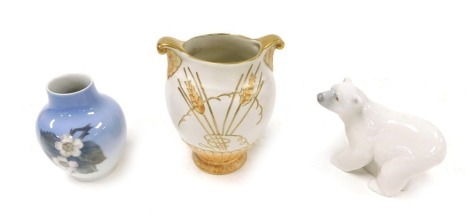 A Lladro porcelain figure of a polar bear, Fieldings Crown Devon pottery Art Deco vase, of twin handled semi fluted form, tube lined decorated with corn, M454, printed and painted marks, 13.5cm high, and a Royal Copenhagen porcelain vase decorated with bl