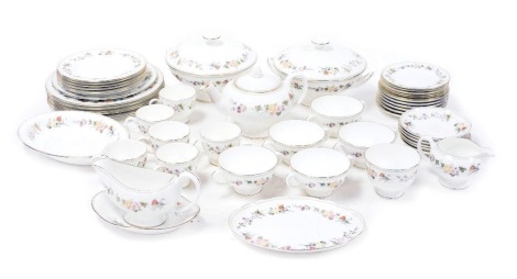 A Wedgwood porcelain Mirabelle pattern part dinner and tea service, comprising pair of vegetable tureens and covers, sauce boat on stand, oval serving dish, six dinner and dessert plates, five soup cups and six saucers, tea pot, bread and cake plates, cre