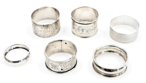 Six silver napkin rings, variously decorated, 3.55oz.