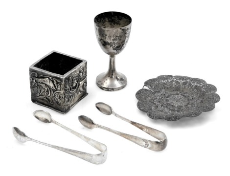 An Edward VII silver bottle holder, with embossed decoration of birds, flowers and foliate scrolls, William Comyns, London 1902, 1.21oz, a Chinese silver cup, engraved to C A Parker 1947, Road Trial, 1.29oz, a filigree dish with floral decoration, and two