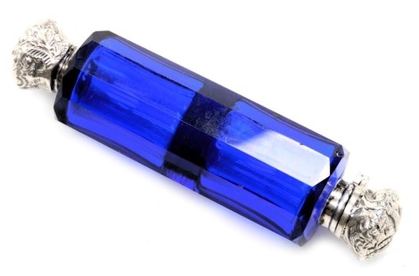 A Victorian Bristol blue glass double ended scent bottle, with hinged and screw lids, white metal, with embossed floral and foliate decoration, 10.5cm wide.