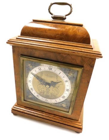 A mid century Elliott walnut cased mantel clock for Pearce and Sons Ltd, Leicester, rectangular brass dial with cherub spandrels, silvered chapter ring bearing Roman numerals, clockwork movement, the case with a domed hood and brass carrying handle, raise