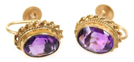 A pair of 9ct gold and amethyst earrings, with a screw fitting, the oval cut stones approximately 1.7ct each, 3.1g all in.