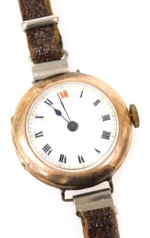 A mid century 9ct rose gold cased lady's wristwatch, circular white enamel dial bearing Roman numerals, fifteen jewelled movement, the case of plain form, on a leather strap.